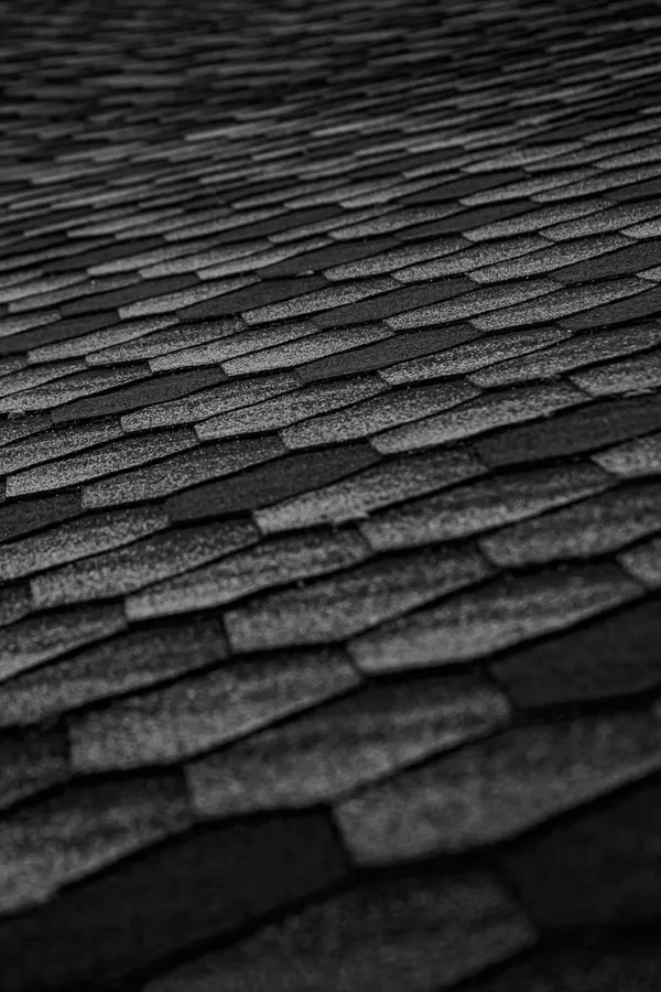 Close texture of dark architectural roof shingles.
